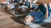 Yoga class on mats stretching